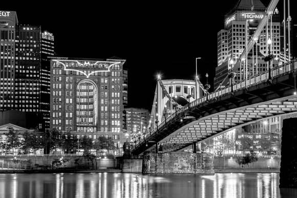 Black and white view of the Bat Signal in downtown Pittsburgh
