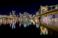 Downtown Pittsburgh and the Bat Signals reflect in the Allegheny River