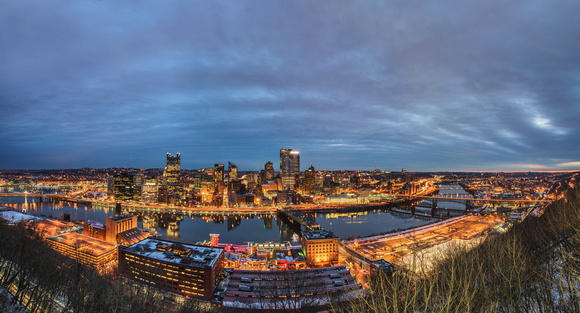 Panorama of Pitttsburgh under cloudy skies at sunrise