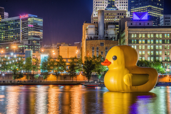 The Giant Rubber Duck in Pittsburgh sits along the Allegheny River with the skyline in the backgroun