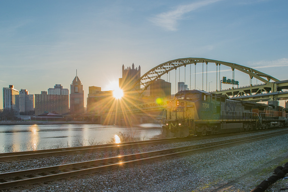 A train passes during sunrise in Pittsburgh