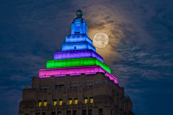 The full moon shines bright by the Gulf Tower in Pittsburgh