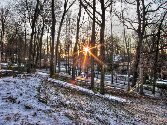 Sunflare through the trees and over the snow HDR