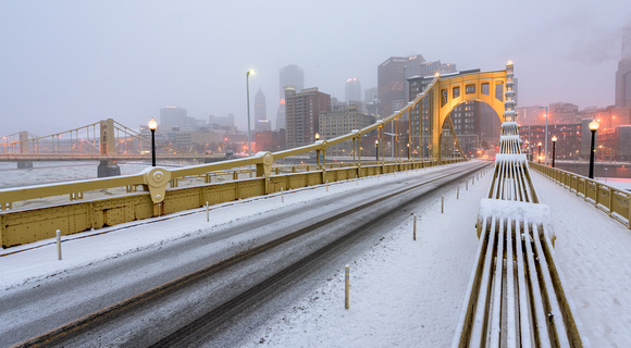 Snow falls on the Clemente Bridge in Pittsburgh