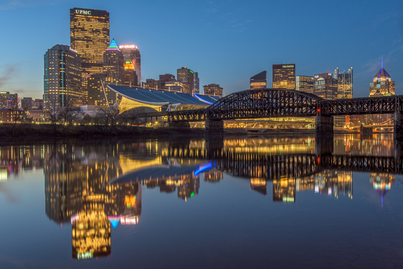 Pittsburgh reflects in the smooth waters of the Allegheny River at dawn