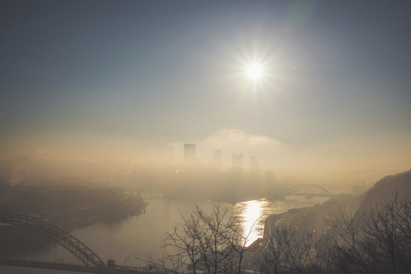 The sun rises above the fog in Pittsburgh from the West End Overlook