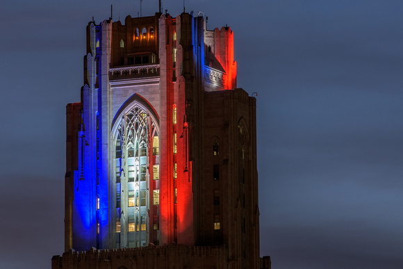 Blue, white and red glow atop the Cathedral of Learning
