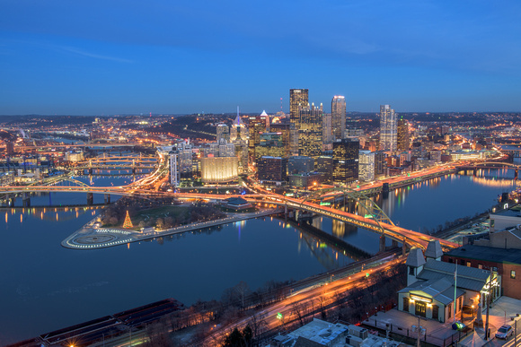 Pittsburgh reflects in calm waters during a winter blue hour