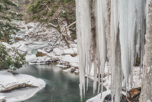 Long exposure of giant icicles and the stream in the winter at Ohiopyle State Park