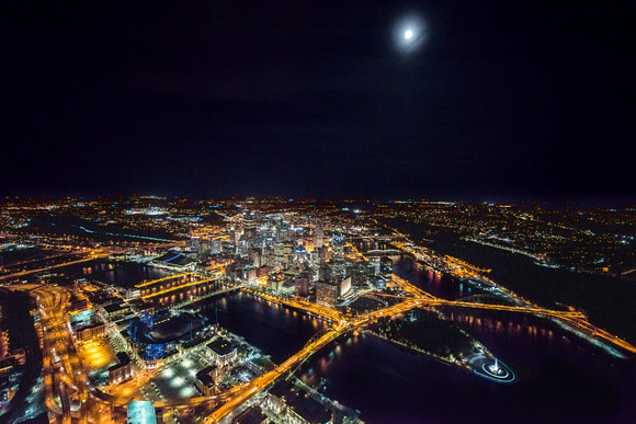 A full moon shines over Pittsburgh at night from the air