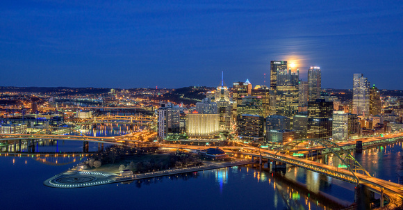 The Pittsburgh skyline and a full moon in the winter