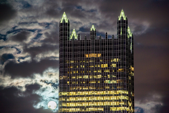The supermoon shines through the clouds near PPG Place in Pittsburgh