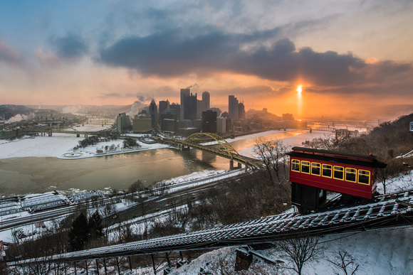 A sun pillar and the Duquesne Incline in Pittsburgh at dawn