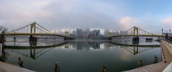 Fog covers the top of the Pittsburgh skyline at dawn panorama