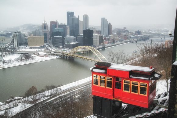 An incline car rides up the Duquesne Incline in the snow in Pittsburgh HDR