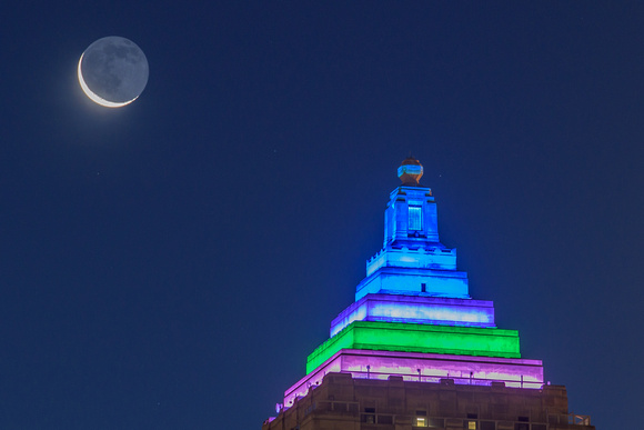 The crescent moon hangs over the Gulf Tower in Pittsburgh