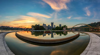 A colorful sunrise reflects in the fountain at the Point in Pittsburgh