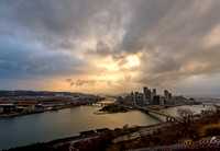 The sun shines through the clouds over Pittsburgh after a snow squall