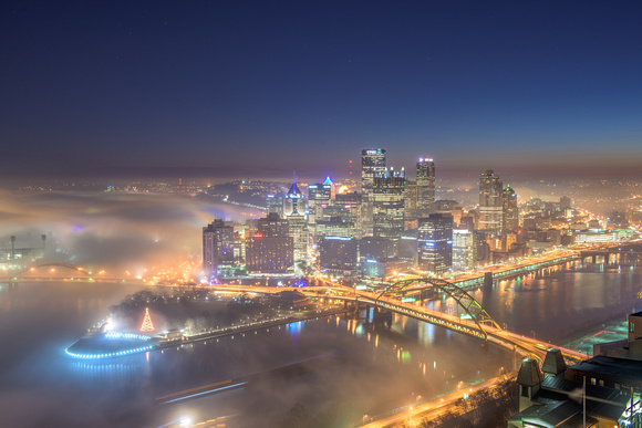 Fog surrounds the Pittsburgh skyline at dawn