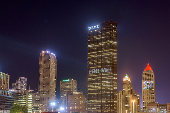 Pens logo projected on downtown Pittsburgh after a win