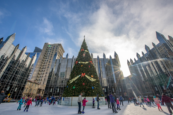 A sunflare shines on skaters at the ice rink in PPG Place in Pittsburgh
