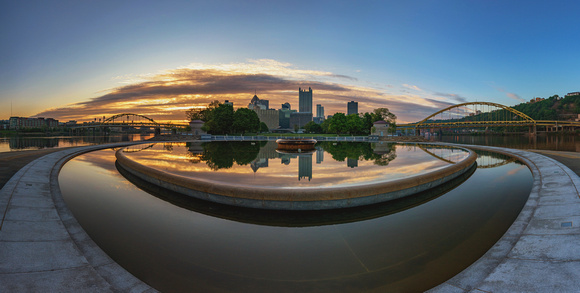 Panorama of Pittsburgh reflecting in the fountain at dawn