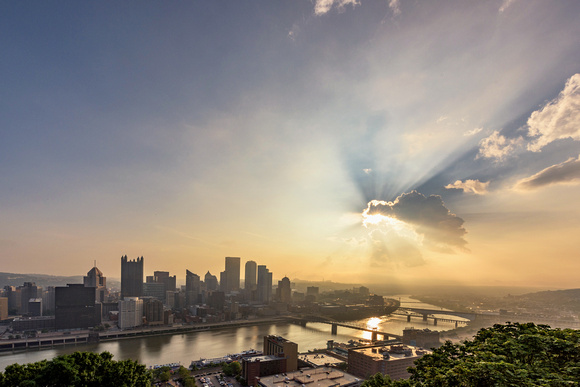 The sun bursts through the clouds during a beautiful Pittsburgh sunrise