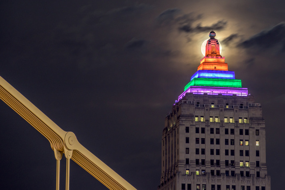 The full moon shines behind the Gulf Tower in Pittsburgh