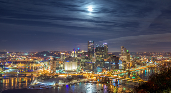A full moon over Pittsburgh in the clouds