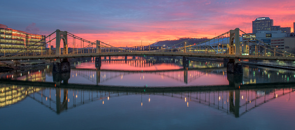 Bridges and sunrise reflect in the Allegheny River in Pittsburgh