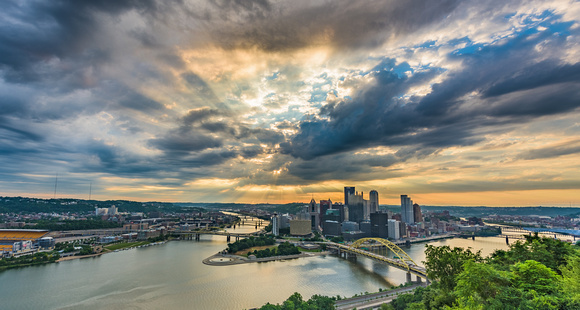 The sun bursts through the clouds during a beautiful Pittsburgh sunrise