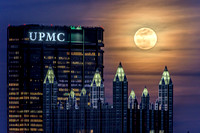 A full moon sits in the spires of PPG Place in Pittsburgh
