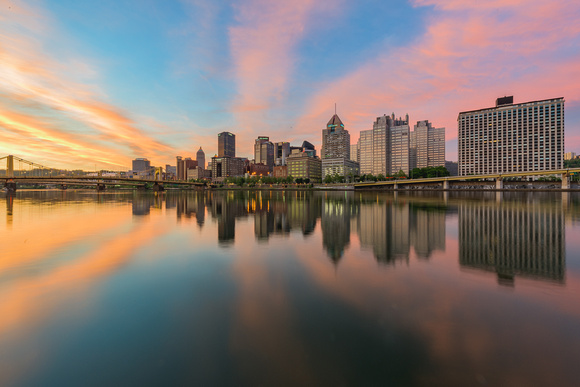 A colorful sunrise reflects in the Allegheny River in Pittsburgh