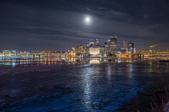 The full moon reflects in the icy waters of Pittsburgh