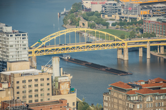 A barge passes under the Ft. Duquesne Bridge in Pittsburgh