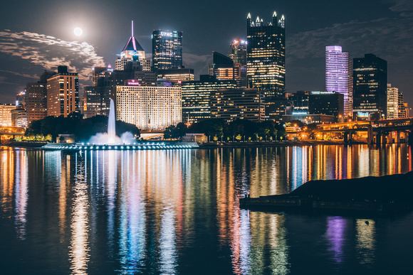 The full moon reflects in the rivers of Pittsburgh