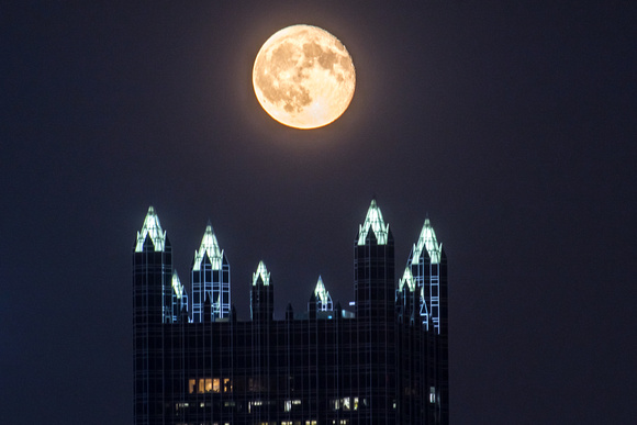 The moon hangs low over PPG Place in Pittsburgh