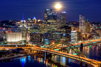 The bright full moon glows over the Pittsburgh skyline