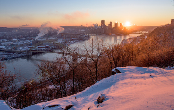 The snow glows pink at dawn from the West End in Pittsburgh