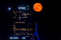 The moon glows beside the Steel Building in Pittsburgh
