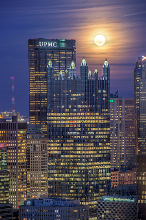 PPG Place and the Steel Building sit under a full moon in Pittsburgh