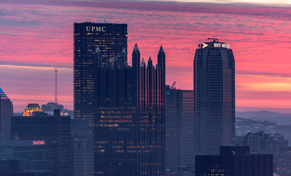 A pink sky behind Pittsburgh at dawn