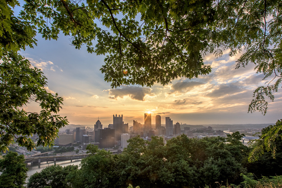 Trees on Mt. Washington frame the Pittsburgh skyline during a beautiful sunrise
