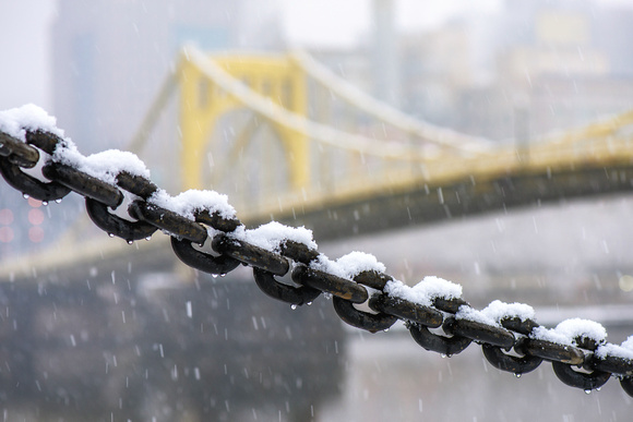 Snow falls on a chain on the North Shore of Pittsburgh