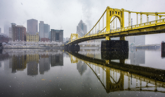 Snow falls around the Clemente Bridge in Pittsburgh during a storm