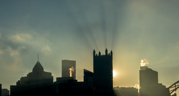 Rays of light burst from the top of PPG Place