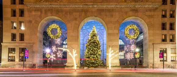 Cars streak by the Christmas tree at the City County Building in Pittsburgh