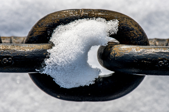Close up of snow on a chain link in Pittsburgh