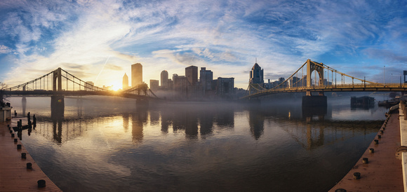 A panorama of Pittsburgh during a foggy sunrise
