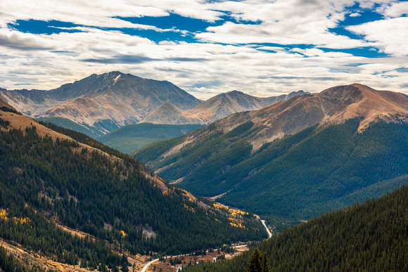 A winding road cuts through the mountains far below Independence Pass in Colorado